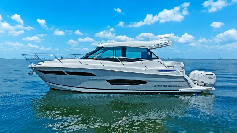 Slide: The Image of Starboard Profile of 2025 Regal 38 EXC This image showcases the sleek starboard profile of the 2025 Regal 38 EXC by Galati Yacht Sales. The vessel features a streamlined hull with modern lines and expansive windows, enhancing both aesthetics and natural light. Equipped with powerful twin outbo - 7180472