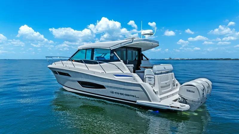 Slide: The Image of Starboard Aft View with Outboards This image showcases the sleek starboard aft view of the 2025 Regal 38 EXC by Galati Yacht Sales. The vessel is equipped with powerful twin Yamaha outboard engines, ensuring exceptional performance and handling. The expansive cockpit features elegant seat - 7180471