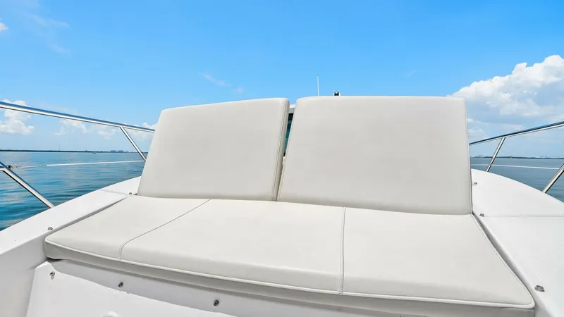 Slide: The Image of Spacious Bow Sunpad Seating The Regal 38 EXC features a luxurious bow sunpad, perfect for lounging under the sun. The plush, upholstered seating offers comfort and style, complementing the sleek lines of the yacht. Enjoy unobstructed ocean views and relaxation on this well-appointed - 7180461