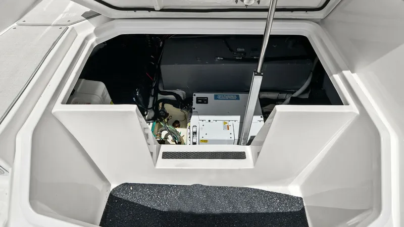 Slide: The Image of Engine Compartment Access Hatch The image showcases the well-organized engine compartment of the 2025 Regal 38 EXC. The hatch provides easy access to critical mechanical components, ensuring effortless maintenance and inspection. The clean layout and secure latch system highlight the ve - 7180455