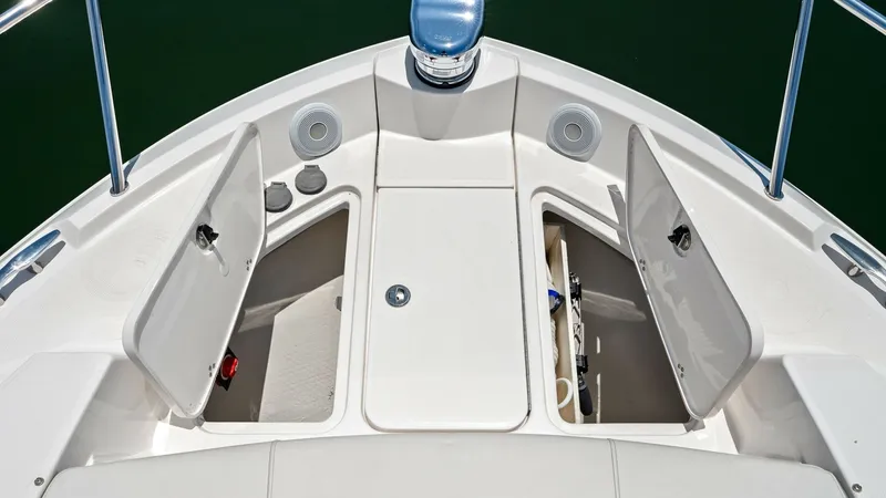 Slide: The Image of Foredeck Storage Compartments This image showcases the foredeck of the Regal 38 EXC, featuring convenient storage compartments on either side. The clean, white finish and integrated speakers highlight the vessel's modern design and functionality. Ideal for organizing gear, these compa - 7180463