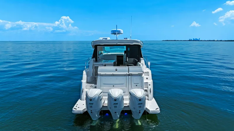 Slide: The Image of Aft View with Triple Outboards The Regal 38 EXC showcases its powerful triple outboard engines in this stunning aft view, promising exceptional performance on the water. The spacious swim platform enhances accessibility and leisure activities, while the sleek design of the transom comp - 7180469