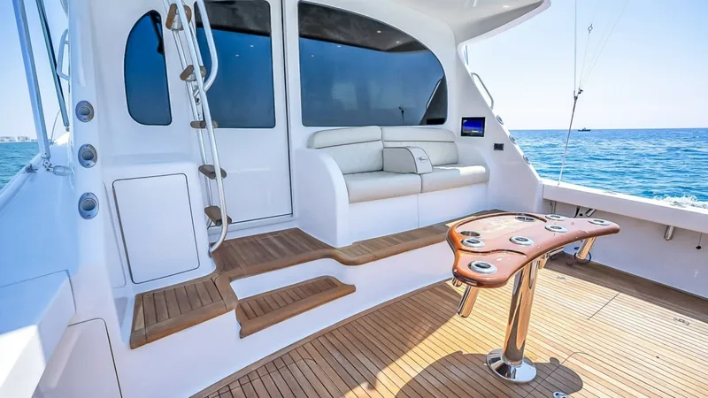 Slide: The Image of Spacious Cockpit with Seating Area This image showcases the elegant cockpit of the 2021 Viking 48 Convertible. Featuring a beautifully crafted teak deck, this area is equipped with a stylish fighting chair that offers functionality for fishing enthusiasts. The plush seating area provides c - 7224851