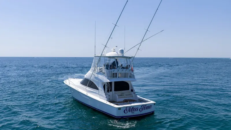 Slide: The Image of Aft Deck and Tower View This image showcases the aft deck of the 2021 Viking 48 Convertible, highlighting its spacious cockpit ideal for fishing and leisure. The tower provides excellent visibility and control, perfect for sportfishing enthusiasts. The clean lines and elegant de - 7224924