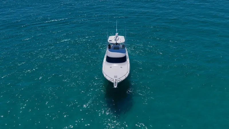 Slide: The Image of Aerial Bow View in Open Water This aerial shot captures the sleek, powerful profile of the 2021 Viking 48 Convertible's bow cutting through crystal-clear waters. The vessel's elegant lines and robust craftsmanship are on full display, highlighting its exceptional design and performanc - 7224930