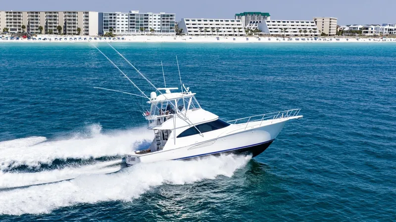 Slide: The Image of Viking 48 Convertible Cruising The 2021 Viking 48 Convertible is captured gracefully slicing through the water, showcasing its sleek and powerful design. The dynamic hull ensures a smooth and fast ride, perfect for both leisurely cruises and sportfishing adventures. Its striking exteri - 7224913
