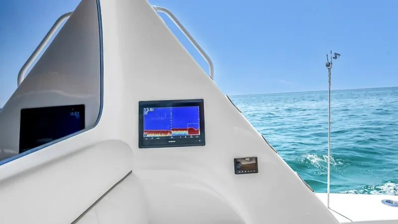 Slide: The Image of Flybridge Helm Station The flybridge helm station of the 2021 Viking 48 Convertible showcases an advanced navigation display against a sleek, white console. The ergonomic design ensures comfort and easy access to controls, enhancing the captain's command of the vessel. Enjoy pa - 7224886