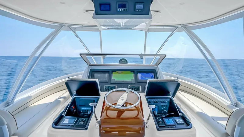 Slide: The Image of Flybridge Helm Station The helm station on the Viking 48 Convertible offers a commanding view of the open sea. Featuring state-of-the-art navigation systems and dual multifunction displays, this space ensures precise control and safety. The ergonomic design and luxurious seatin - 7224850