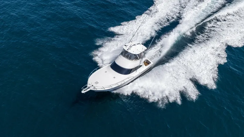 Slide: The Image of Aerial View of Viking 48 Convertible This striking aerial shot captures the Viking 48 Convertible, slicing through the water with power and elegance. The sleek design and substantial flybridge make it a standout vessel, showcasing its impressive seakeeping abilities. The spacious foredeck an - 7224922
