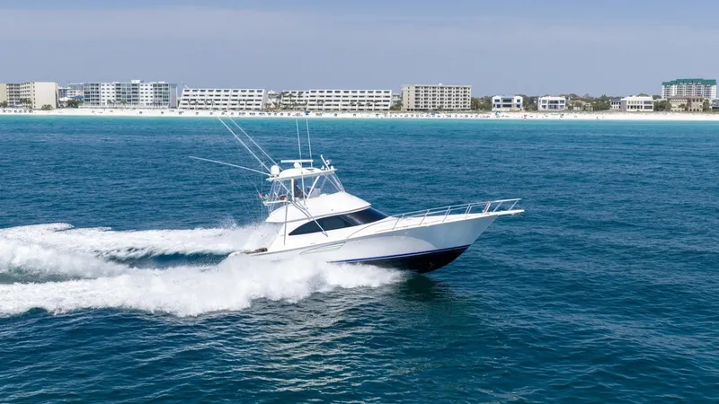 Slide: The Image of Viking 48 Convertible at Sea The 2021 Viking 48 Convertible, 'High Impact', showcases its sleek profile as it cuts through the open water with ease. The vessel's aerodynamic design and powerful engines create an impressive wake, highlighting its performance capabilities. With a spaci - 7224920
