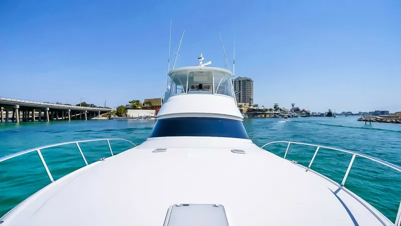 Slide: The Image of Bow View of Viking 48 Convertible This image captures the sleek bow of the 2021 Viking 48 Convertible, showcasing its elegant lines and modern design. The expansive foredeck is ideal for sunbathing or enjoying panoramic views while cruising. The elevated flybridge provides excellent visib - 7224892