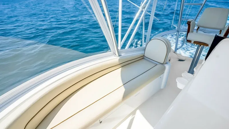 Slide: The Image of Flybridge Seating with Ocean View Experience comfort and luxury on the flybridge of the 2021 Viking 48 Convertible. This area features plush cream-colored seating that offers a perfect vantage point for enjoying panoramic ocean views. The sleek railings and clear windscreen enhance the op - 7224901