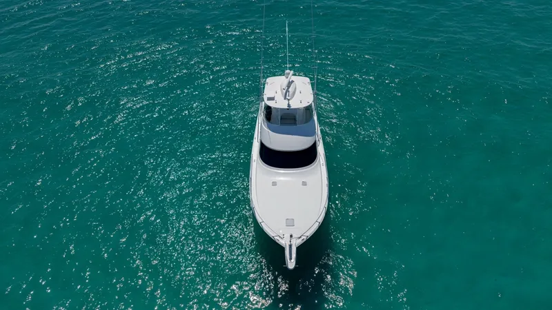 Slide: The Image of Aerial View of Bow at Sea This image showcases the sleek bow of the 2021 Viking 48 Convertible, cutting gracefully through the azure waters. The clean lines and spacious foredeck highlight the yacht's modern design and functionality. Ideal for both leisure and sport fishing, this - 7224931