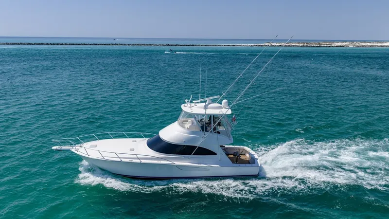 Slide: The Image of Side View of Viking 48 Convertible This image captures the sleek profile of the 2021 Viking 48 Convertible, showcasing its elegant lines and robust flybridge. The vessel glides effortlessly through the water, highlighting its superior performance and craftsmanship. Perfect for sportfishing - 7224912