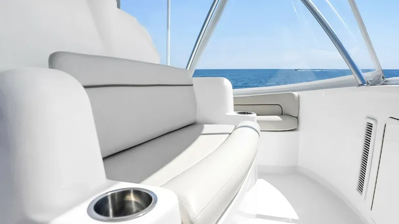 Slide: The Image of Flybridge Seating Area This image showcases the flybridge seating area of the 2021 Viking 48 Convertible. The plush, wrap-around seating offers both comfort and style, ideal for enjoying panoramic ocean views. Stainless steel cup holders and sleek, modern finishes enhance the l - 7224902
