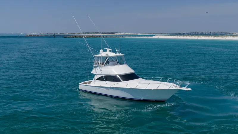 Slide: The Image of Aerial View of Viking 48 Convertible This image showcases the sleek and powerful profile of the 2021 Viking 48 Convertible, 'High Impact'. The vessel's elegant design is highlighted by its streamlined hull and spacious flybridge, perfect for both sportfishing and leisure cruising. Surrounded - 7224923