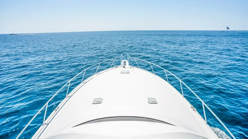 Slide: The Image of Bow View Over Open Water This image captures the sleek bow of the 2021 Viking 48 Convertible, cutting gracefully through the calm, open waters. The clean lines and sturdy railings emphasize the vessel's robust design, while the expansive ocean view highlights its capability for a - 7224893