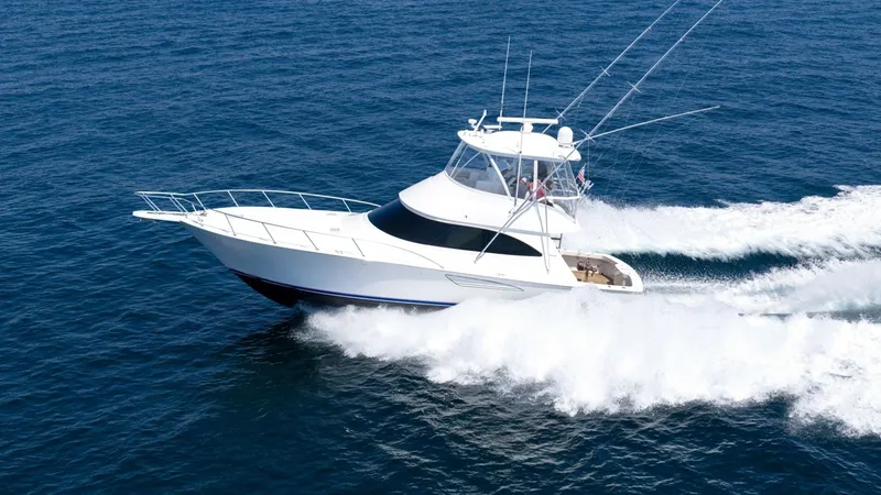 Slide: The Image of Side Profile of Viking 48 Convertible This image showcases the sleek and powerful side profile of the 2021 Viking 48 Convertible, cutting effortlessly through the water. The vessel's distinctive lines and robust build highlight its exceptional craftsmanship and performance capabilities. With - 7224916