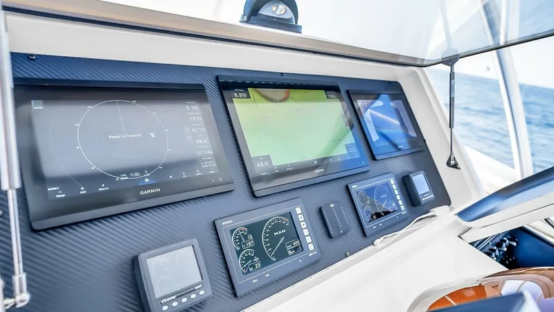 Slide: The Image of Advanced Helm Navigation Display The helm of the 2021 Viking 48 Convertible features an advanced navigation display with multi-functional Garmin screens for precise control and monitoring. The carbon fiber paneling adds a sleek, modern touch, while the ergonomic layout ensures ease of us - 7224898