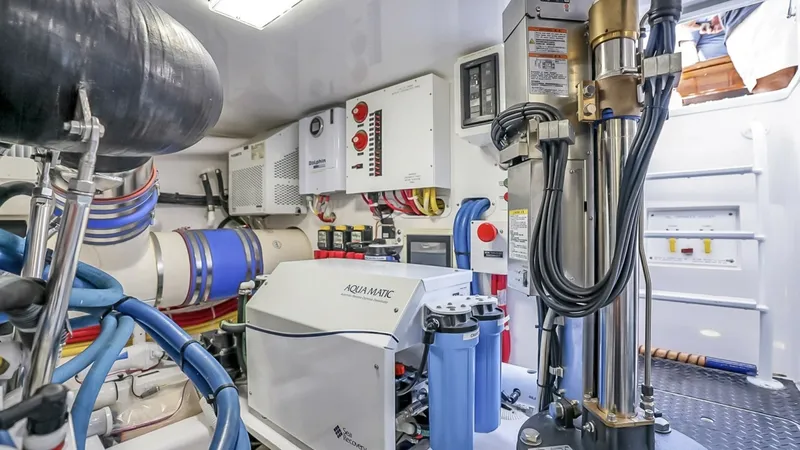 Slide: The Image of Engine Room with Watermaker System The engine room of the 2021 Viking 48 Convertible is meticulously organized, featuring advanced systems like the AquaMatic watermaker. The space is equipped with high-quality components for optimal performance and efficiency. Bright overhead lighting ensu - 7224909
