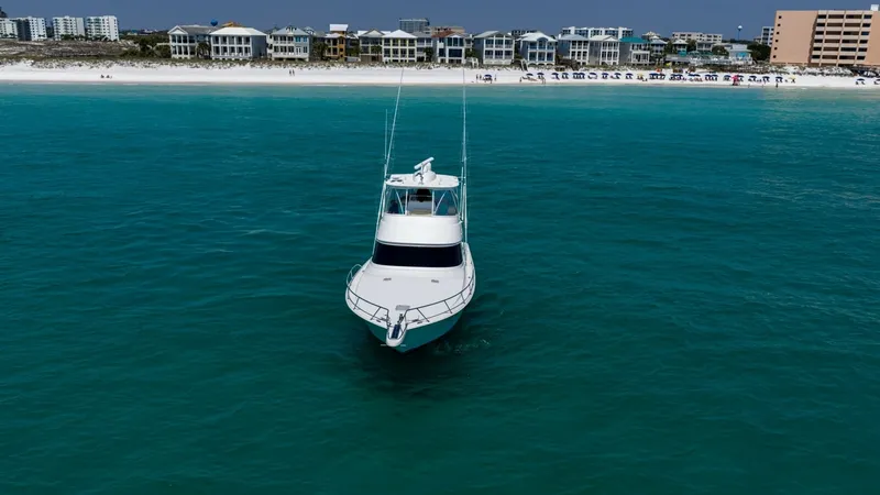 Slide: The Image of Bow View from Ocean This striking image captures the bow of the 2021 Viking 48 Convertible, aptly named 'High Impact,' cutting through the vibrant turquoise waters. The vessel's sleek design and robust structure are evident, offering a glimpse of its superior craftsmanship. - 7224933