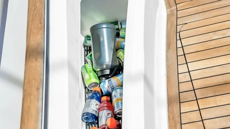 Slide: The Image of Cockpit Beverage Cooler This image showcases the convenient beverage cooler located in the cockpit of the 2021 Viking 48 Convertible. The cooler is seamlessly integrated into the deck, providing easy access to refreshments while maintaining the sleek design of the vessel. The te - 7224890
