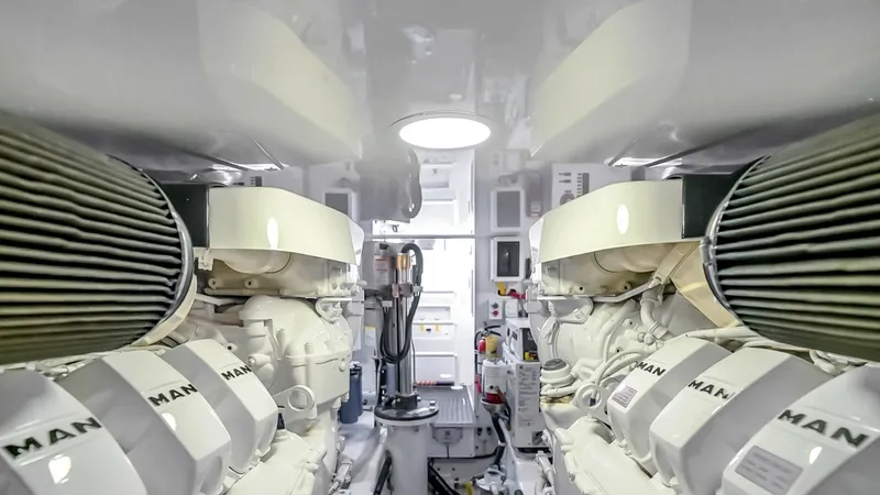 Slide: The Image of Engine Room with MAN Engines The engine room of the 2021 Viking 48 Convertible showcases dual MAN engines, renowned for their power and reliability. The space is meticulously organized, with bright overhead lighting ensuring easy access and maintenance. The high-quality finishes and - 7224908