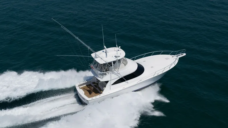 Slide: The Image of Aerial View of Viking 48 Convertible The 2021 Viking 48 Convertible cuts through the water with impressive agility and speed, showcasing its sleek design and powerful performance. The flybridge offers a commanding view, equipped with advanced navigation systems, while the spacious aft deck i - 7224914