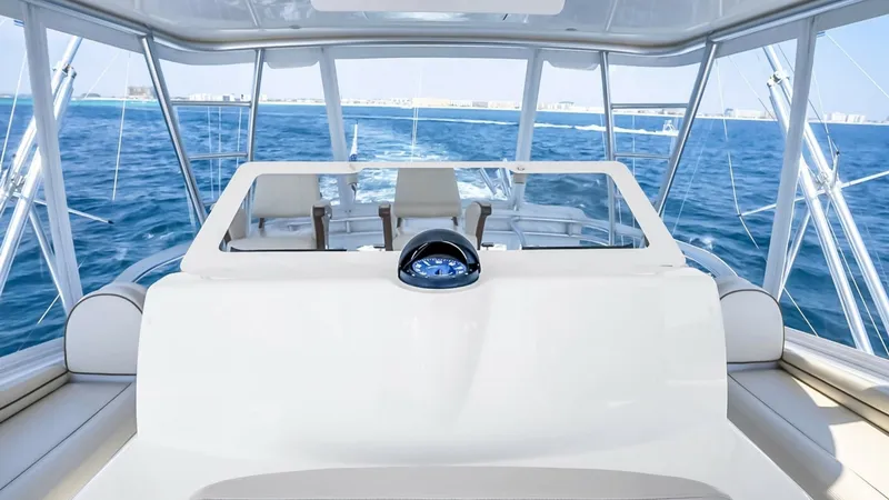 Slide: The Image of Flybridge Helm Station with Ocean View This image showcases the helm station on the flybridge of the 2021 Viking 48 Convertible. The expansive glass provides panoramic ocean views, enhancing navigation and leisure. The helm features state-of-the-art instrumentation and comfortable seating, mak - 7224900