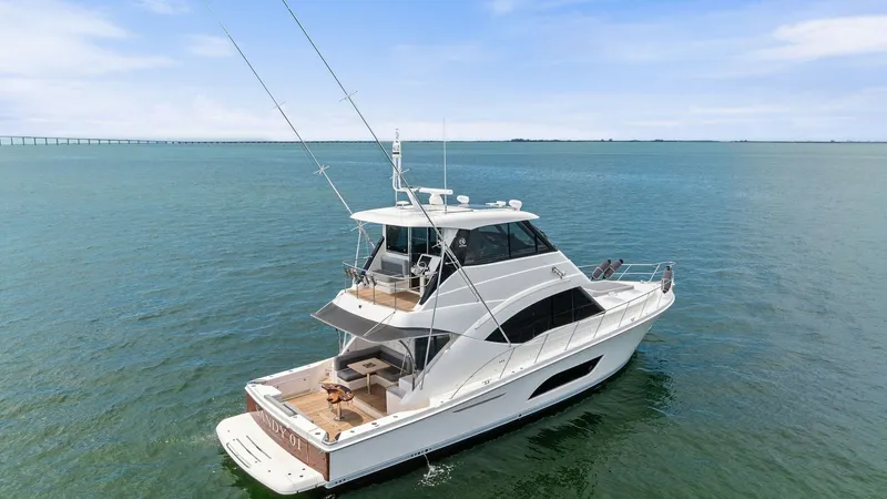 Slide: The Image of Aerial View of Riviera 57 Aft Deck This image showcases the sleek design of the 2021 Riviera 57 Enclosed Bridge from an elevated perspective. The aft deck features a spacious seating area perfect for entertaining, complemented by elegant teak finishes. The enclosed bridge provides excellen - 7541536