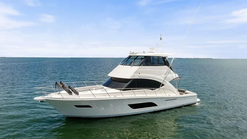 Slide: The Image of Side Profile of Riviera 57 Enclosed Bridge This image showcases the sleek side profile of the 2021 Riviera 57 Enclosed Bridge, highlighting its modern and aerodynamic design. The enclosed bridge offers expansive windows for unobstructed views while cruising. The vessel's elegant lines and robust c - 7541538