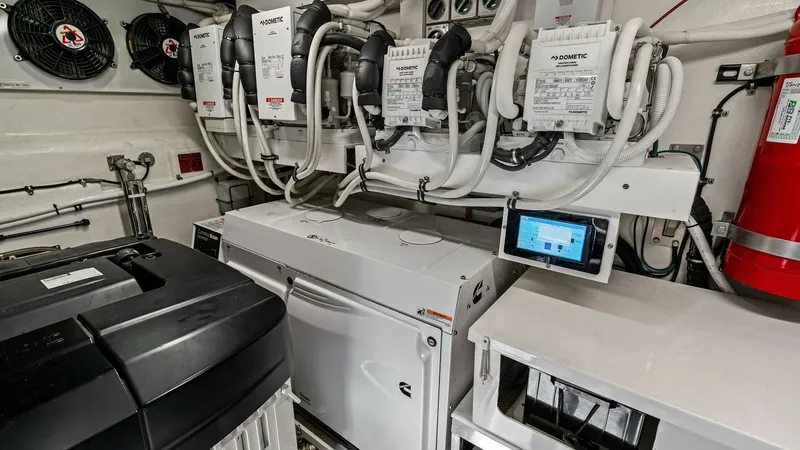 Slide: The Image of Engine Room with Advanced Systems The engine room of the 2021 Riviera 57 Enclosed Bridge showcases advanced systems and meticulous organization. Featuring state-of-the-art equipment, it includes robust air conditioning units and a comprehensive control panel for efficient operation. The c - 7541528