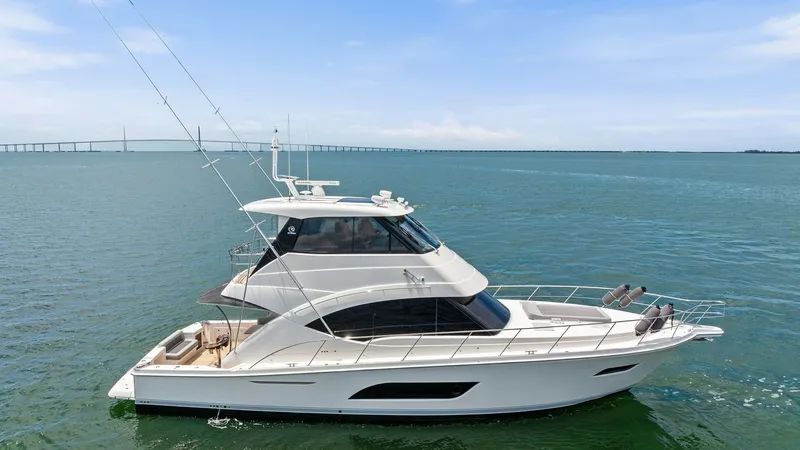 Slide: The Image of Side Profile of Riviera 57 Enclosed Bridge This image showcases the elegant side profile of the 2021 Riviera 57 Enclosed Bridge. The sleek lines and spacious flybridge highlight the yacht's modern design and superior craftsmanship. The expansive windows provide ample natural light, while the well- - 7541544