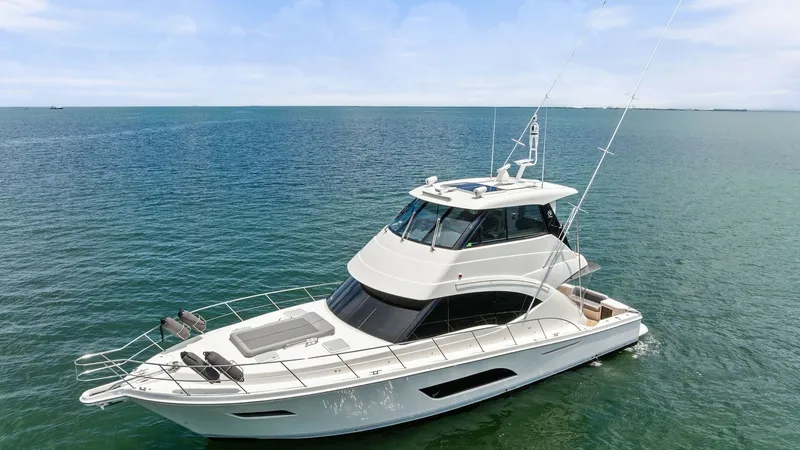 Slide: The Image of Aerial View of Enclosed Bridge The 2021 Riviera 57 Enclosed Bridge showcases its sleek design and spacious flybridge from an aerial perspective. The yacht's elegant lines and expansive windows emphasize its modern aesthetic and provide panoramic views. The well-appointed deck space, co - 7541539