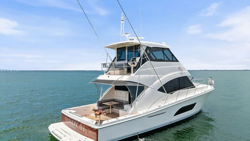 Slide: The Image of Aft View with Enclosed Flybridge The 2021 Riviera 57 Enclosed Bridge showcases a sleek aft view, emphasizing its spacious cockpit and integrated swim platform. The enclosed flybridge offers premium visibility and protection, ideal for all-weather navigation. Elegant exterior lines and hi - 7541533