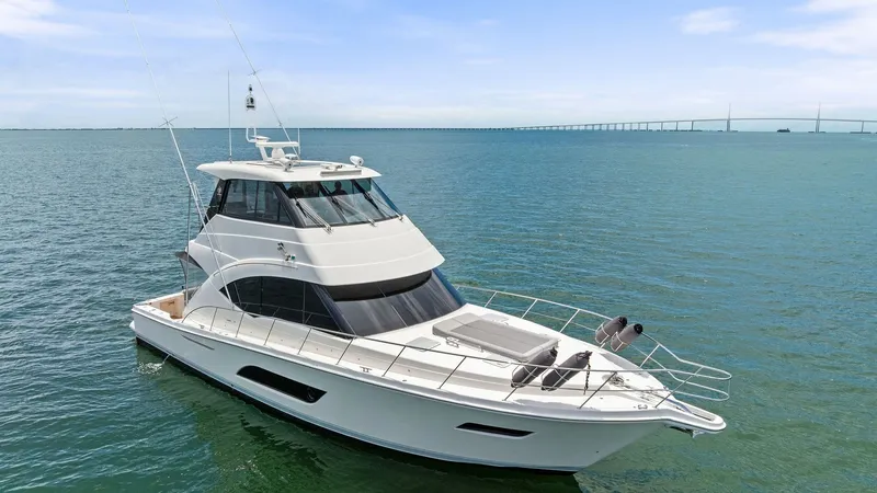 Slide: The Image of Aerial View of Enclosed Bridge The 2021 Riviera 57 Enclosed Bridge showcases sleek lines and a sophisticated profile from an aerial perspective. The enclosed bridge offers panoramic views, enhancing both navigation and leisure experiences. The spacious foredeck and elegant design highl - 7541534