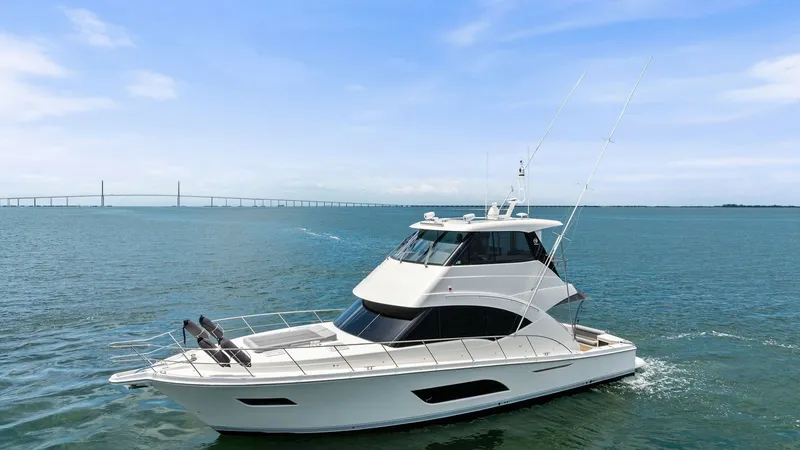 Slide: The Image of Side Profile of Riviera 57 Enclosed Bridge This image showcases the sleek side profile of the 2021 Riviera 57 Enclosed Bridge, highlighting its elegant lines and modern design. The enclosed bridge provides expansive views and protection from the elements, while the spacious foredeck features sun p - 7541530