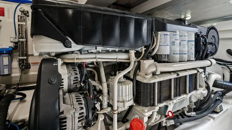 Slide: The Image of Engine Room with Volvo Penta Engine The image showcases the engine room of the 2021 Riviera 57 Enclosed Bridge, featuring a robust Volvo Penta engine. This meticulously organized space highlights high-performance components and superior engineering, ensuring reliability and efficiency on th - 7541527