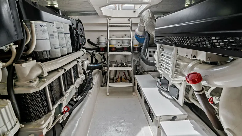 Slide: The Image of Engine Room with Volvo Penta Engines This image showcases the meticulously organized engine room of the 2021 Riviera 57 Enclosed Bridge. Featuring powerful Volvo Penta engines, the space is designed for optimal functionality and ease of maintenance. The clean layout, ample lighting, and acce - 7541526