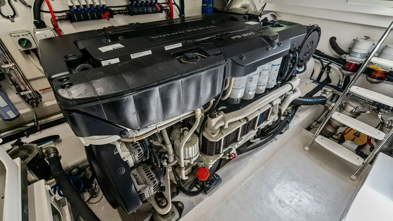 Slide: The Image of Engine Room with Twin Diesel Engines The engine room of the 2021 Riviera 57 Enclosed Bridge showcases powerful twin diesel engines, meticulously organized for optimal performance. The clean and spacious layout includes easy access to critical systems and components, enhancing maintenance eff - 7541524
