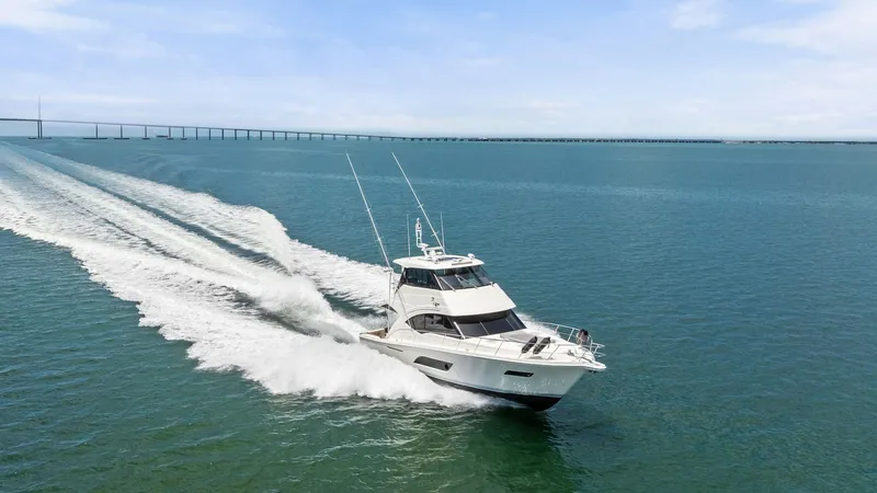 Slide: The Image of Riviera 57 Enclosed Bridge Cruising The 2021 Riviera 57 Enclosed Bridge is captured cruising smoothly across the open water, showcasing its sleek design and powerful performance. The vessel's elegant lines and robust structure are complemented by its enclosed bridge, offering panoramic view - 7541546
