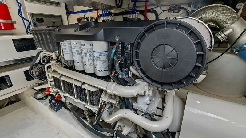 Slide: The Image of Engine Room with Volvo Penta Engine This image showcases the meticulously maintained engine room of the 2021 Riviera 57 Enclosed Bridge, featuring a powerful Volvo Penta engine. The space is well-organized with clearly labeled components, ensuring easy access for maintenance. The high-quali - 7541523