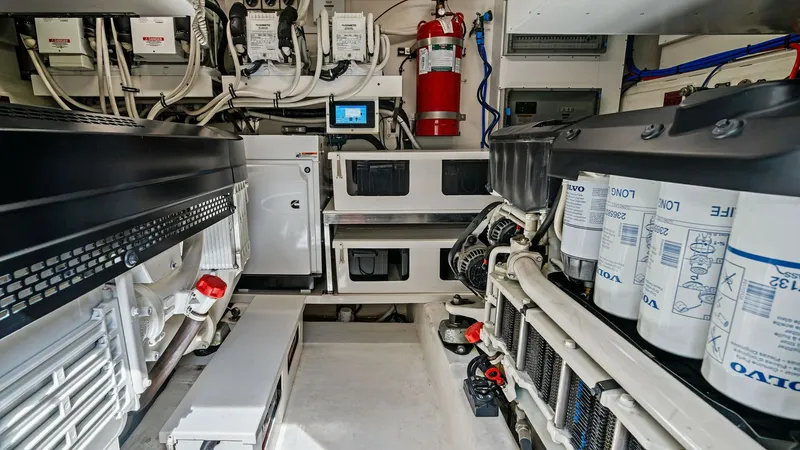Slide: The Image of Engine Room with Advanced Systems The engine room of the 2021 Riviera 57 Enclosed Bridge showcases state-of-the-art engineering with neatly organized components and systems. The space features high-quality machinery, including dual engines and advanced filtration systems, ensuring optimal - 7541522