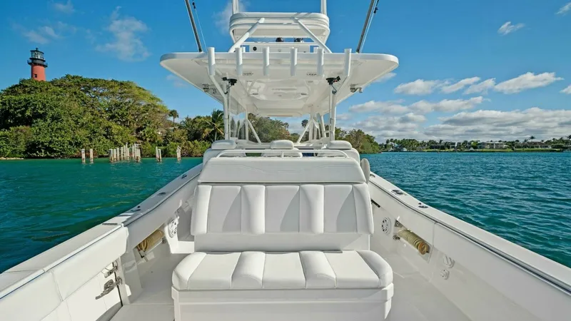 Slide: The Image of Aft Deck Seating with Tower The Invincible 42 Open Fisherman's aft deck features plush white seating, offering comfort and style for guests. The sleek design is complemented by a sturdy tower, providing excellent visibility and a perfect vantage point for fishing or sightseeing. The - 7285528