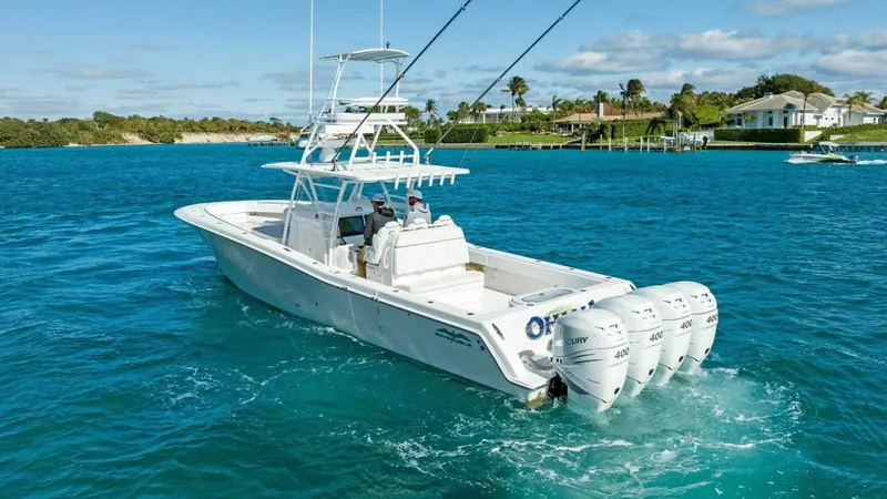 Slide: The Image of Aft View with Quad Outboards The 2019 Invincible 42 Open Fisherman, 'Ohana', is showcased here with a powerful quad outboard engine setup, ensuring exceptional performance on the water. The spacious aft deck is designed for serious fishing with ample room for movement and storage. Th - 7285534