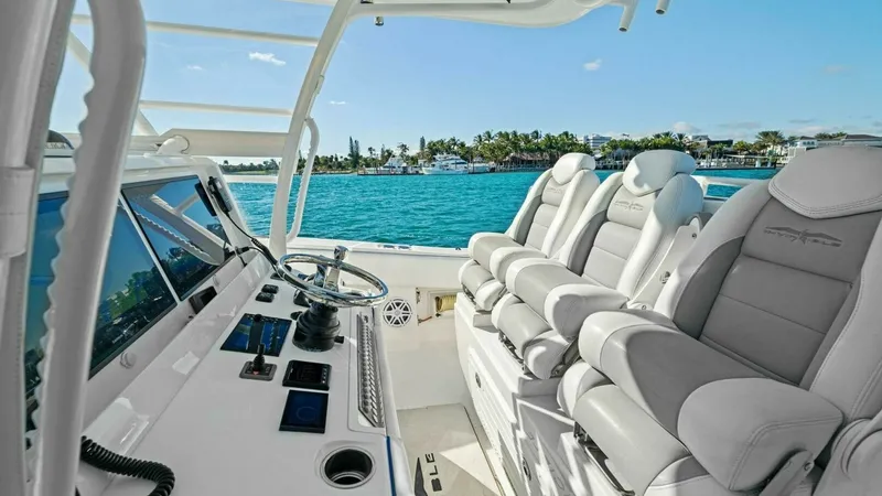 Slide: The Image of Helm Station with Seating This image showcases the helm station of the 2019 Invincible 42 Open Fisherman. Featuring a sleek console with state-of-the-art navigation electronics, it offers an intuitive and commanding vantage point. The plush, ergonomic seating ensures comfort durin - 7285506