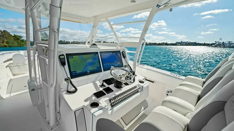 Slide: The Image of Helm Station with Dual Displays The helm station of the 2019 Invincible 42 Open Fisherman features advanced dual navigation displays, providing comprehensive control and visibility for the captain. Ergonomically designed seating ensures comfort during long excursions, while the sleek st - 7285510