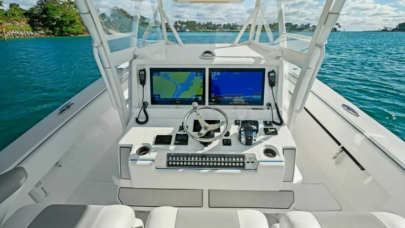 Slide: The Image of Helm Station with Twin Displays The helm station of the 2019 Invincible 42 Open Fisherman features dual high-definition navigation displays, providing precise control and navigation. The ergonomic layout includes a stainless-steel steering wheel, electronic throttle controls, and easy a - 7285507