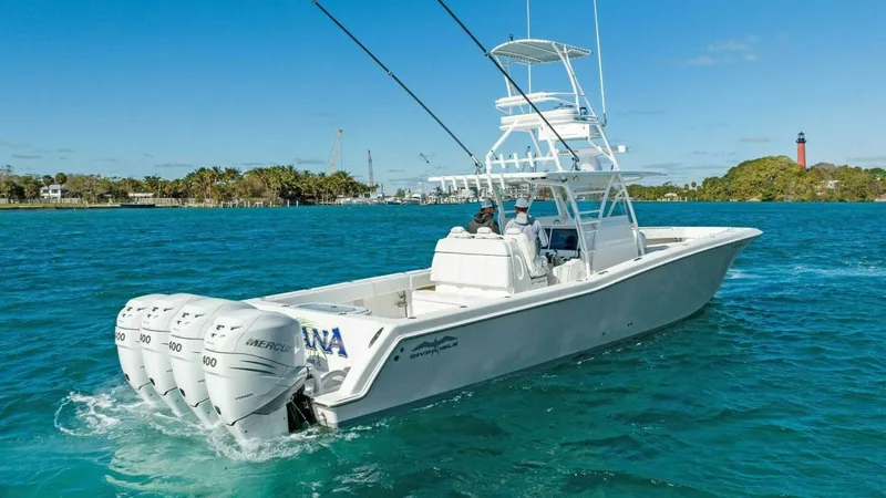 Slide: The Image of Aft View with Quad Outboards This image showcases the aft section of the 2019 Invincible 42 Open Fisherman, featuring four powerful Mercury outboard engines. The spacious deck offers ample room for fishing or leisure, accentuated by the sleek, professional design. The elevated helm p - 7285533