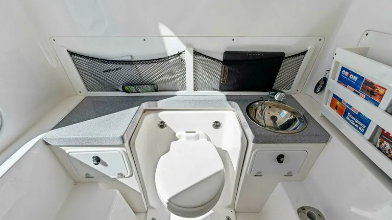 Slide: The Image of Compact Marine Head with Sink This functional marine head features a compact design with integrated storage compartments and a stainless steel sink. The practical layout maximizes space, offering convenient storage nets and shelves for essentials. Perfectly suited for extended trips, - 7285518
